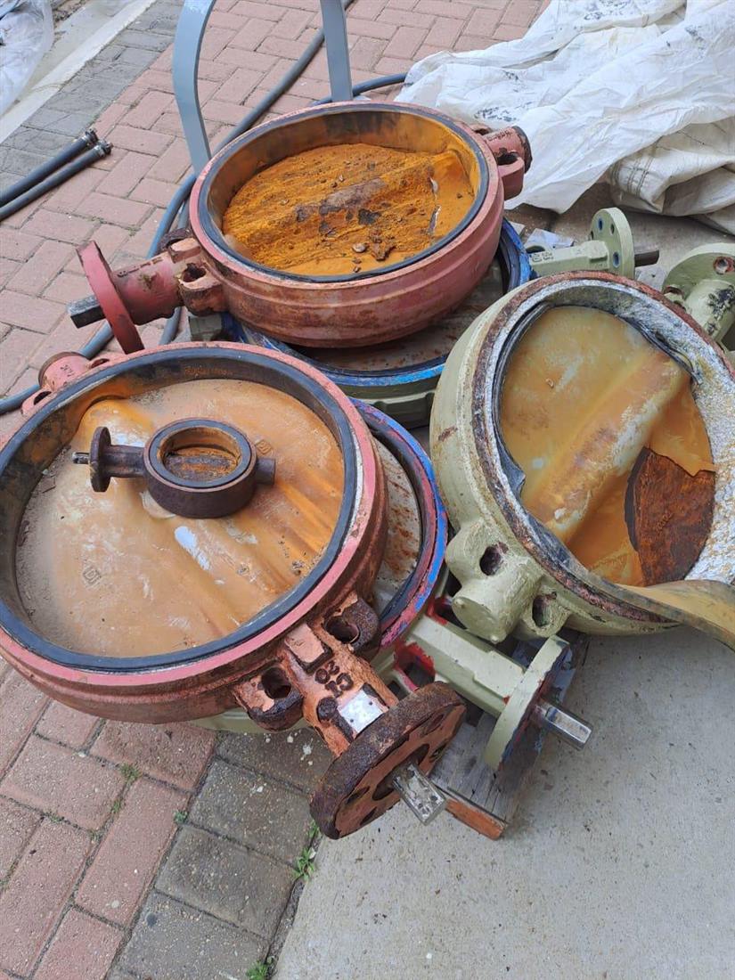 Heavily corroded butterfly valves awaiting corrosion coating at the Amanzi workshop in Bellville